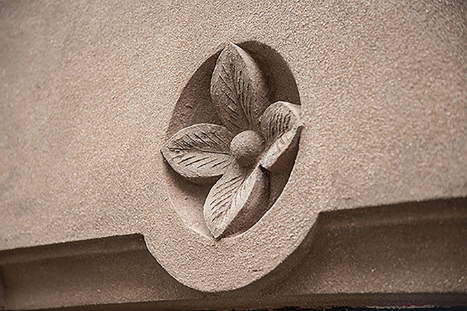 Detail of a hand-sculpted flower rondel from the Ziehl/Starr Residence historic facade restoration project
