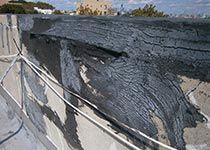 A deteriorated roof parapet